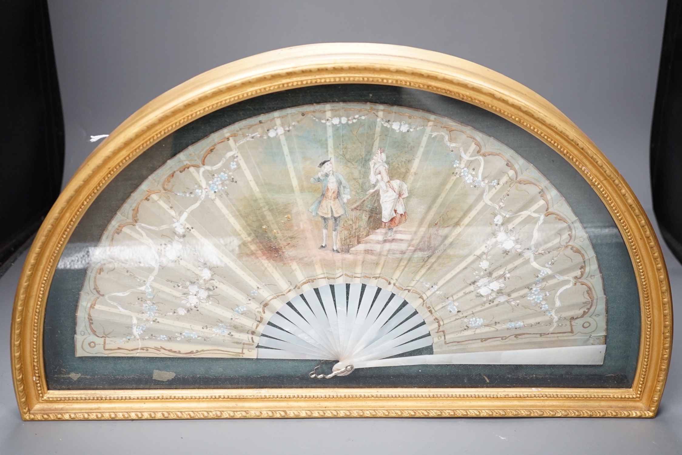 A framed Victorian figuratively painted fan with mother of pearl guards